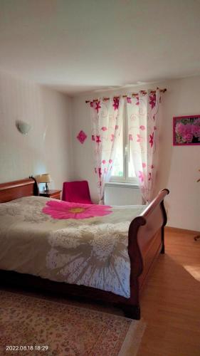 a bedroom with a large bed and a window at Chambre à louer chez l'habitant in Payré