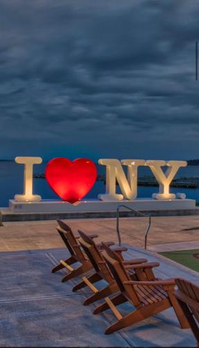 a red heart is sitting between two chairs at The Fallen Tree Inn in Geneva