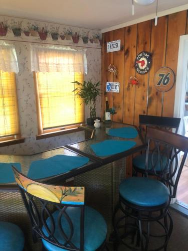 a dining room with blue chairs and a table at The Fallen Tree Inn in Geneva