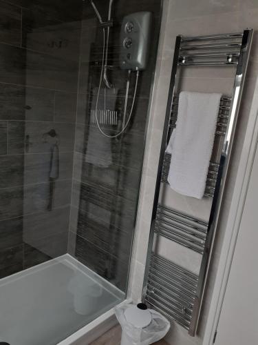 a bathroom with a shower with a glass shower stall at Cuddys Corner in Beadnell