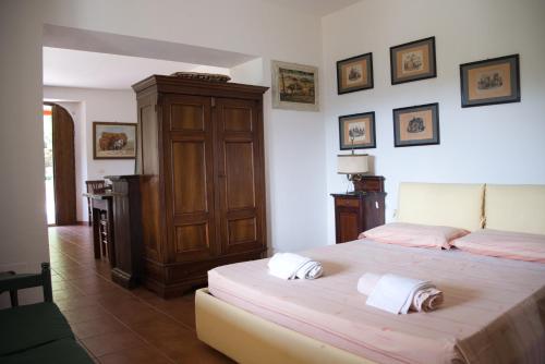 a bedroom with two beds and a wooden cabinet at Agriturismo Il Casaletto in Montefranco
