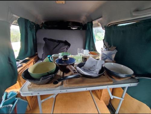 a table in the back of a camper with bowls and pans at Beautiful Campervan to Rent in Santa Cruz de Tenerife