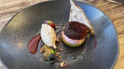 a black plate with a dessert on a table at Holiday Inn Düsseldorf-Neuss by IHG in Neuss