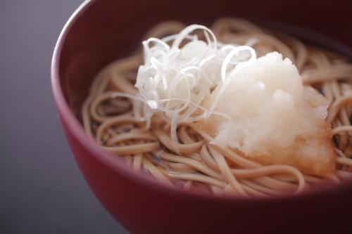 a red bowl filled with noodles and a pile of rice at Sakaeya in Yamanouchi