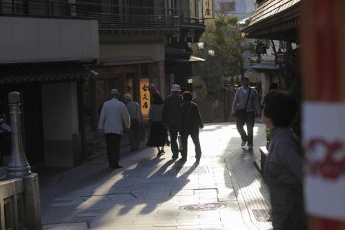 a group of people walking down a street at Sakaeya in Yamanouchi