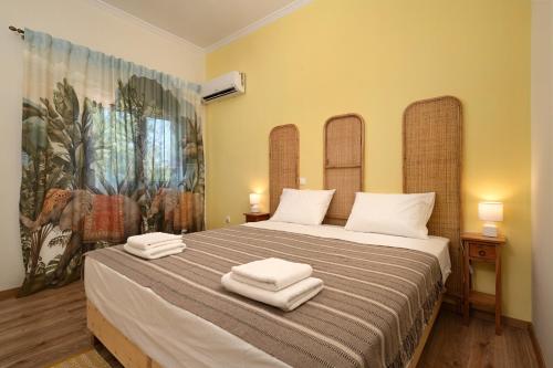 a bedroom with a large bed with towels on it at Angel luxury villa in Petrití