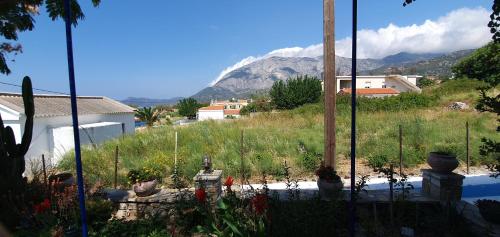 a view of a garden with a mountain in the background at Jenny Apartments in Karlovasi