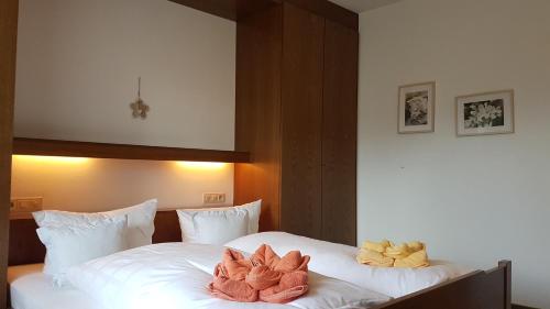a bedroom with a bed with two stuffed animals on it at Haus Vierjahreszeiten in Reit im Winkl