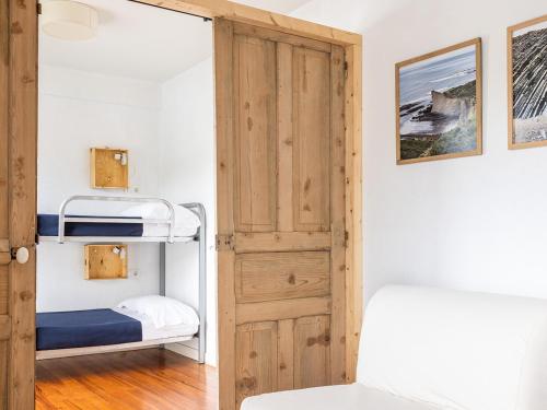 a small bedroom with a bunk bed and a door at Zarautz Hostel in Zarautz