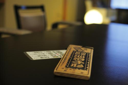 a remote control sitting on top of a table at Sakaeya in Yamanouchi