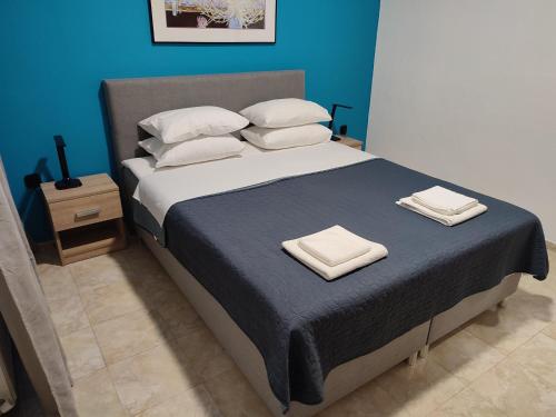 a bedroom with a large bed with towels on it at Asterios House in Kriopigi