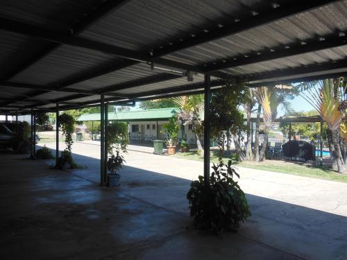 a covered patio with plants in a building at Country Road Motel in Charters Towers