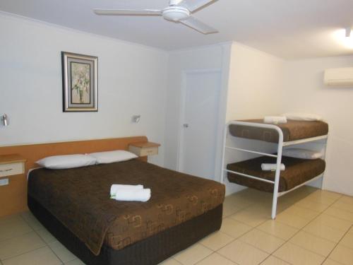 a hotel room with a bed and aroll at Country Road Motel in Charters Towers