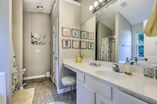 a bathroom with a sink and a large mirror at Boho Union City Home Less Than 20 Mi to Dtwn Atlanta! in Union City