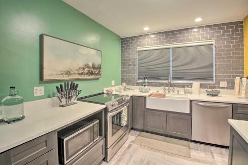 a large kitchen with a sink and a window at 2 Mi to Central Ave Quaint Hot Springs Home! in Hot Springs