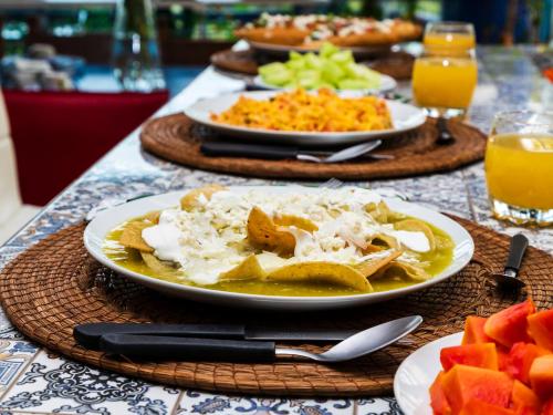 a table with plates of food on a table at Casa Itzae B&B Polanquito Dog Friendly in Mexico City