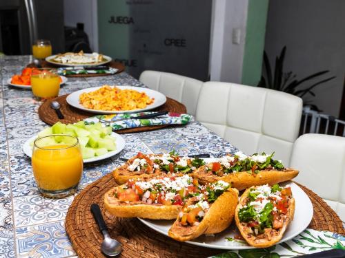 a table topped with plates of food and bread at Casa Itzae B&B Polanquito Dog Friendly in Mexico City