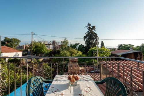 a table on the balcony of a house at Aroni Cretan comfortable house - Hamam suites Aroni in Arónion