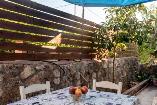 a table with a bowl of fruit on top of it at Aroni Cretan comfortable house - Hamam suites Aroni in Arónion