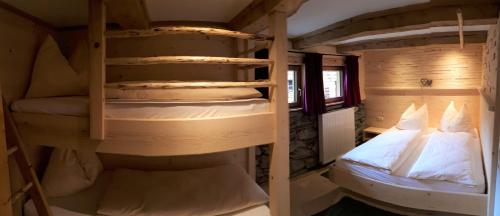 a couple of bunk beds in a room at Vorderkaseralm in Sankt Johann im Pongau