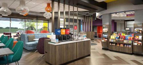 a lobby of a store with chairs and a counter at Tru By Hilton Manteca in Manteca