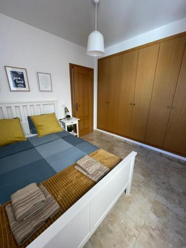 a bedroom with a large bed with yellow pillows at UIM Mediterraneo FELIPE 8 WIFI in Puerto de Sagunto