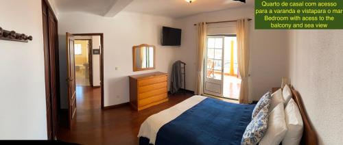 a bedroom with a bed and a dresser and a mirror at Villa Kethellen in Porto Covo