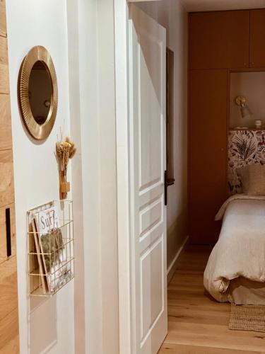 a door leading to a bedroom with a bed at Appartement Biarritz hypercentre calme, plage à 350m in Biarritz