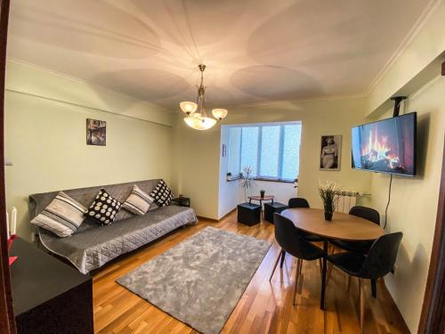 a living room with a couch and a table at Sunrise Apartments City Center in Bucharest