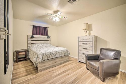 a bedroom with a bed and a chair and a dresser at Convenient Las Cruces Home with Patio and Grill! in Las Cruces