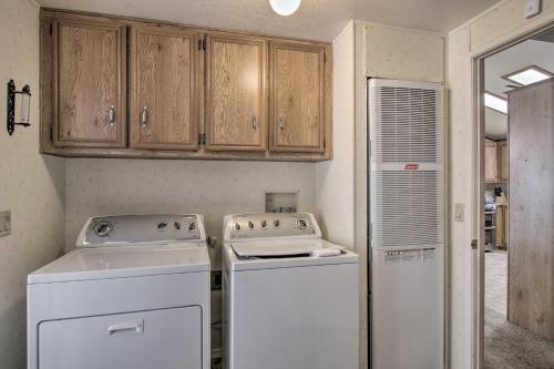 a kitchen with white appliances and wooden cabinets at Family-Friendly Home about 1 Mi to Kern River! in Wofford Heights