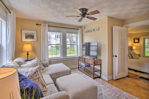 a living room with a couch and a ceiling fan at Modern Home about 2 Mi to Cranmore Mountain Resort! in Conway