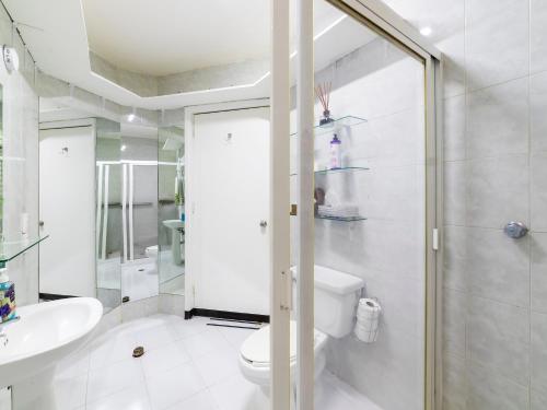 a white bathroom with a toilet and a sink at Casa Itzae B&B Polanquito Dog Friendly in Mexico City
