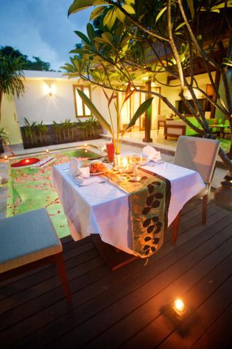 a table with food on it on a patio at The Astari Villa and Residence in Jimbaran