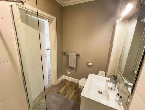 a bathroom with a sink and a glass shower at ShipsBell 5B in St Francis Bay