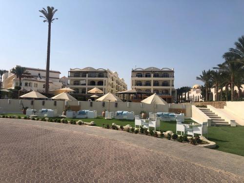 a street in front of a resort with buildings at Apartment with private Beach in Sahl Hasheesh in Hurghada