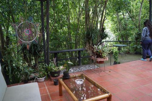 a woman standing on a patio with a bunch of plants at Skale Peregrino in Choachí