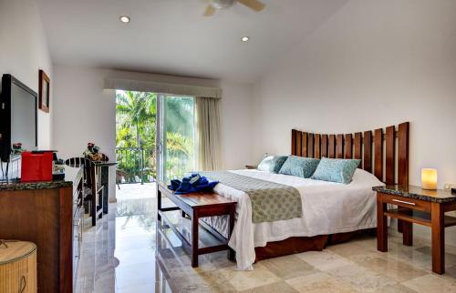 a bedroom with a bed and a sliding glass door at Casa Jaguar in Puerto Aventuras