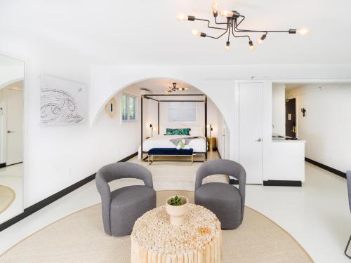a living room with two chairs and a table at Aqua by American Beech - Adults Only in Aquebogue