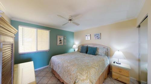 a bedroom with a bed and a window at Beachfront at the Apollo Where the Famous Sunsets Never Get Old! in Marco Island