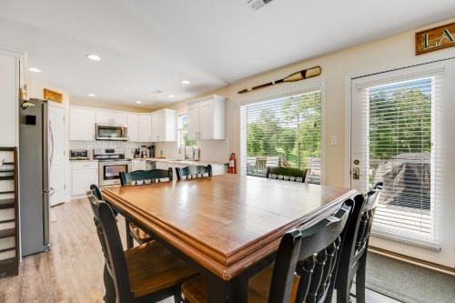 a kitchen and dining room with a wooden table and chairs at Norris Lake Escape in Maynardville
