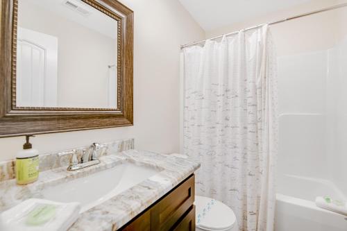a white bathroom with a sink and a mirror at Norris Lake Escape in Maynardville