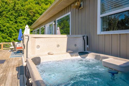 a hot tub on a deck next to a house at Norris Lake Escape in Maynardville