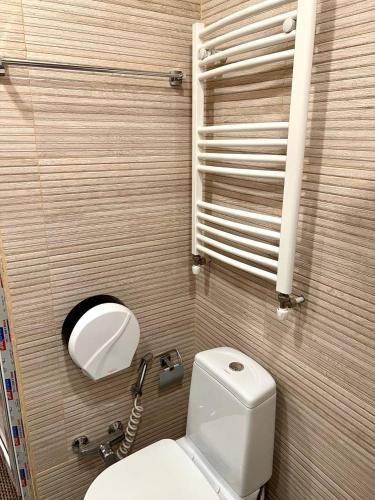 a bathroom with a white toilet and a sink at Best Builder in Tbilisi City