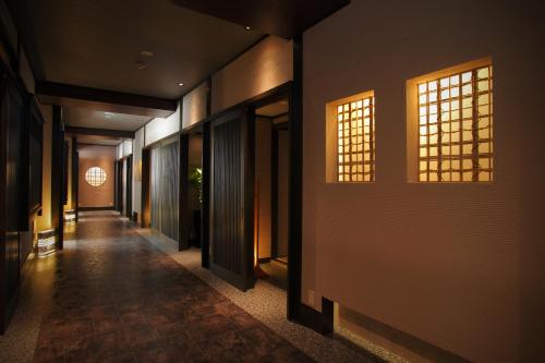 a hallway of a building with two windows at Sakaeya in Yamanouchi