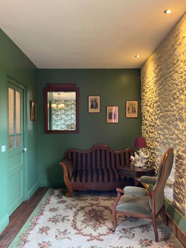a living room with a couch and a table at Le Clos Chalmon Chambre d'hôte in Montignac