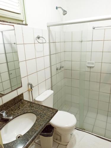 a bathroom with a toilet and a sink and a shower at Ocean Praia Hotel in Fortaleza