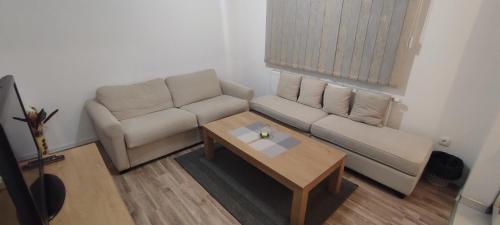 a living room with a couch and a coffee table at Stan na dan "Sanski Most" in Sanski most
