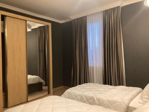 a bedroom with a mirror next to a bed at Lileo in Tsalka
