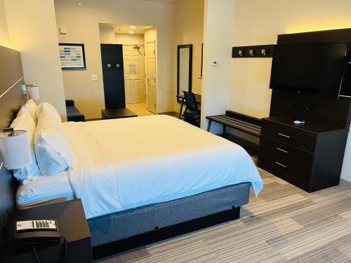 a hotel room with a bed and a piano at Holiday Inn Express & Suites Salinas by IHG in Salinas